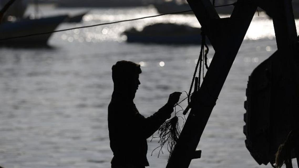 A Palestinian fisherman prepares his boat at the port in Gaza City on March 15, 2017. (AFP)