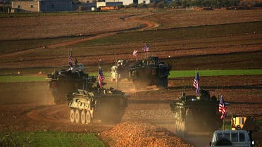 A convoy of US forces armored vehicles drives near the village of Yalanli, on the western outskirts of the Syrian city of Manbij, on March 5, 2017. (AFP)