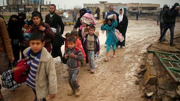 Displaced Iraqis flee their homes on a rainy day as Iraqi forces battle with ISIS, in western Mosul, Iraq March 18, 2017. (Reuters)