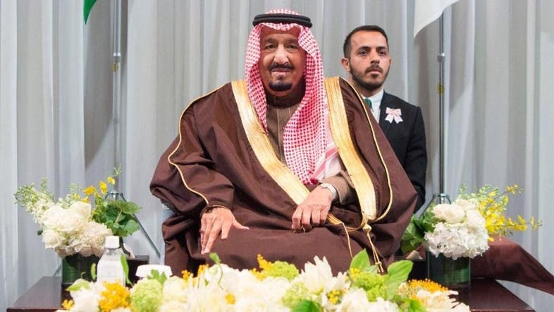 Who was the Saudi scholar who stood behind King Salman in 