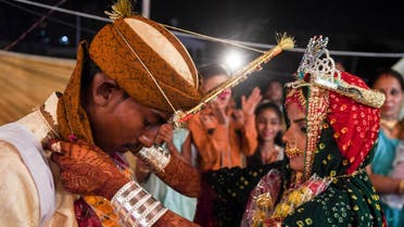 A Pakistani Hindu couple performs a Hindu ritual during a mass wedding ceremony in Karachi, on March 19, 2017. AFP