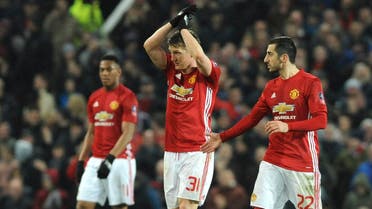 Manchester United's Bastin Schweinsteiger, centre, celebrates with Manchester United's Henrikh Mkhitaryan, right, after scoring during the English FA Cup Fourth Round soccer match between Manchester United and Wigan Athletic at Old Trafford in Manchester, England, Sunday, Jan. 29, 2017. (AP)