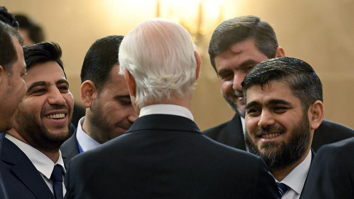 Chief opposition negotiator Mohammad Alloush (R) listens to Staffan de Mistura prior to the first session of Syria peace talks in Astana on January 23, 2017. (AFP)