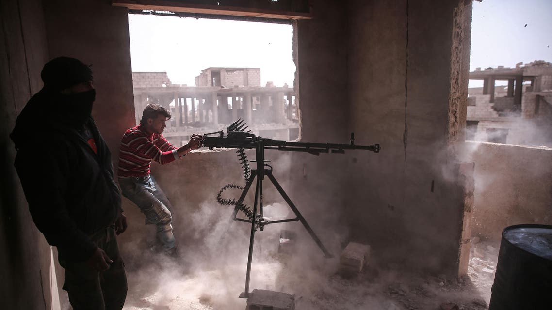 An opposition fighter from the Failaq al-Rahman brigade fires a heavy machine gun in Jobar, a rebel-held district on the eastern outskirts of the Syrian capital Damascus, on March 19, 2017