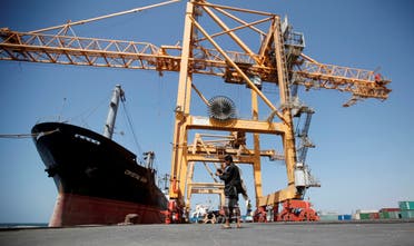 A Houthi militia media officer checks a camera next to giant cranes, damaged by Saudi-led air strikes, at a container terminal at the Red Sea port of Hodeidah, Yemen November 16, 2016