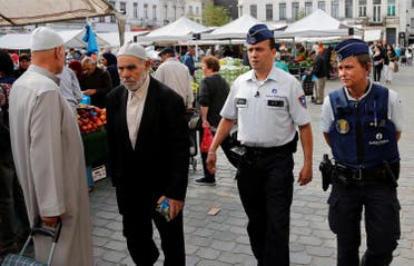 Despite the pride that Chatt says the Molenbeek community feels towards him, there is still stigma attached to working for the police. Officers Ann Vercammen (R) and Tarek Chatt patrol at a market in Belgium. (File Photo: Reuters)