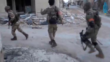 A still image taken from a video uploaded on social media on March 22, 2017, purports to show Tahrir al-Sham rebel fighters running with their weapons, said to be in Soran district, near Hama, Syria. (Reuters)