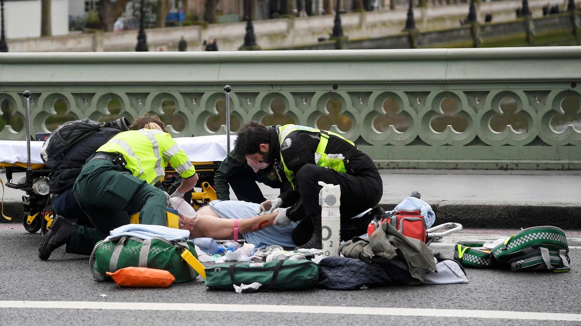 Paramedics treat an inured person after an incident on Westminster Bridge in London, March 22, 2017. reuters