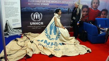 Project ambassador of "Dress For Our Time" Louise Owen models a UN tent from the Zaatari camp in Jordan that has been converted into a dress by fashion academic Helen Storey (R) at the Dubai Humanitarian Aid and Development conference and Exhibition in Dubai on March 22, 2017. afp