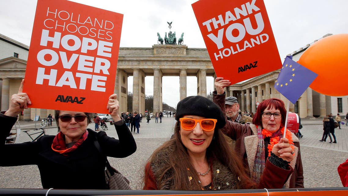 People hold placards to support the election results in the Netherlands during a demonstration in front of the Brandenburg Gate in Berlin, Germany, March 16, 2017. (Reuters)