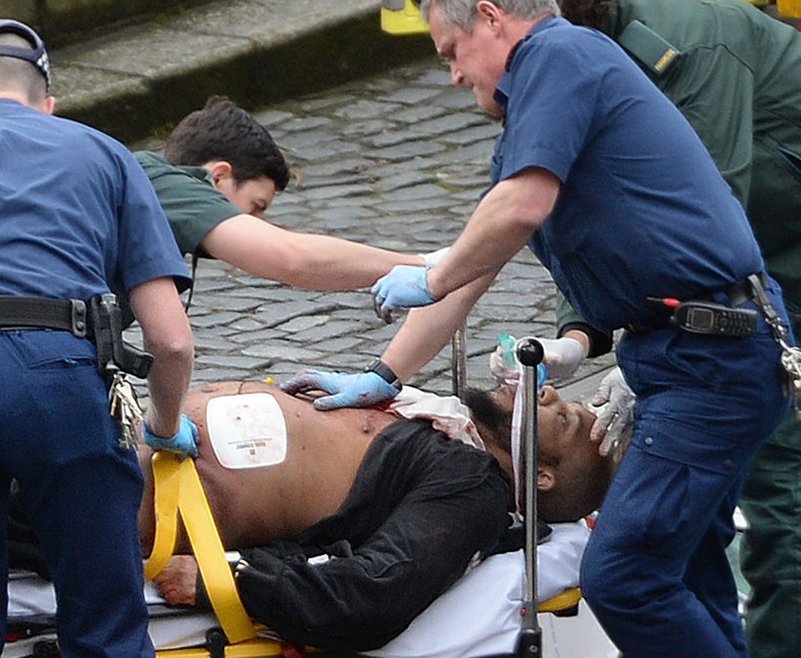 An attacker is treated by emergency services outside the Houses of Parliament London, Wednesday, March 22, 2017. AP 