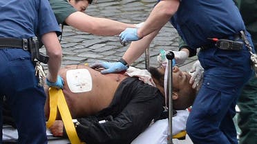 An attacker is treated by emergency services outside the Houses of Parliament London, Wednesday, March 22, 2017. AP 