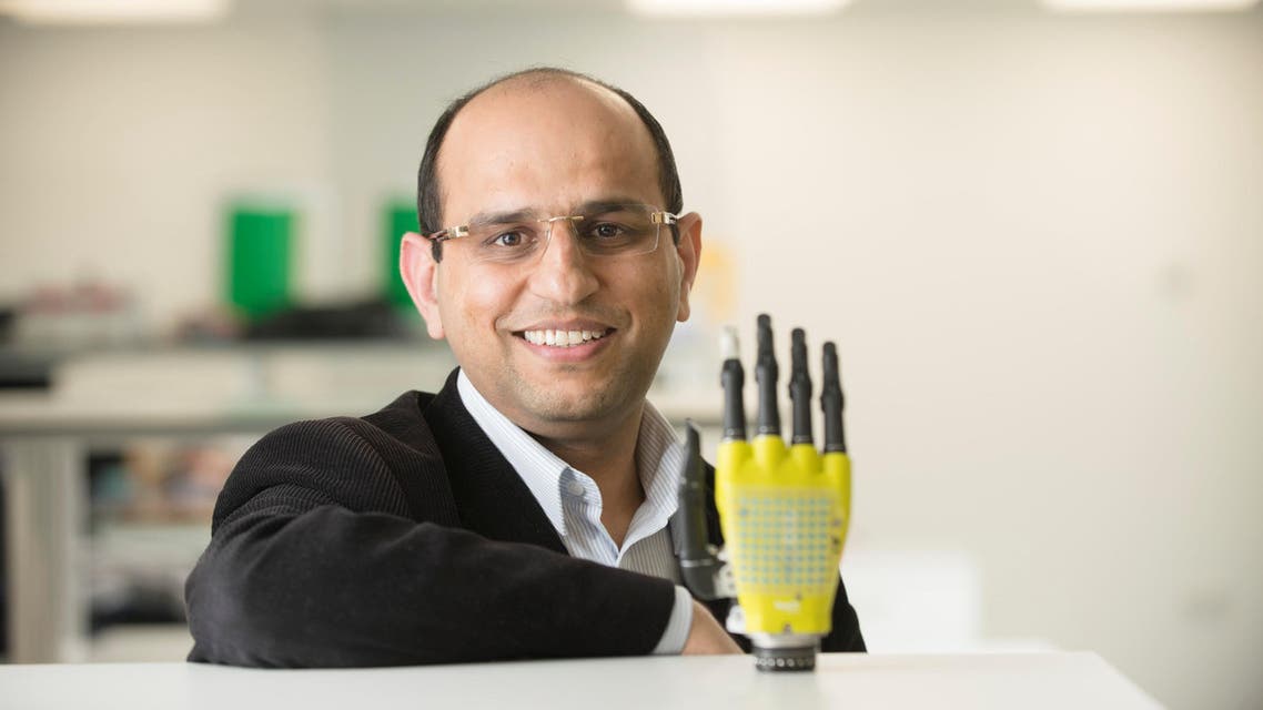Ravinder Dahiya of the University of Glasgow’s School of Engineering poses with the prosthetic hand developed by his team at Glasgow University, Scotland, Britain, on March 11, 2017. (University of Glasgow/ Reuters)