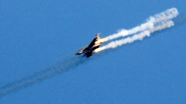 A picture taken on March 23, 2017, shows a Syrian army jet firing rockets over the village of Rahbet Khattab in the Hama province. Jihadists and allied rebels claimed more ground against Syrian government forces in central Hama province, the Syrian Observatory for Human Rights monitor said. (AFP)