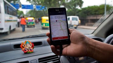 An Indian cab driver displays the city map on a smartphone provided by Uber as he drives in New Delhi, India, Friday, July 31, 2015. (AP)
