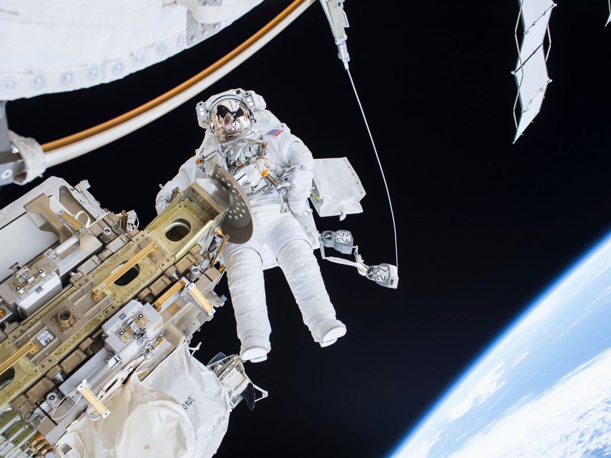 two astronauts floating in space