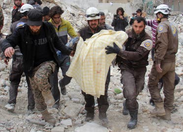 Members of the Syrian civil defence, known as the White Helmets, remove a victim from the rubble of a destroyed building following a reported air strike in the northwestern city of Idlib on March 15, 2017. Omar haj kadour / AFP