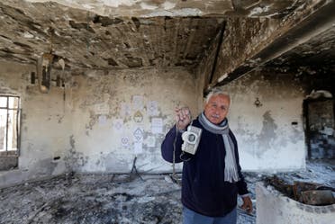 An Iraqi Christian man shows his old camera at his house, which was burned by Islamic State militants before they fled the area, in Qaraqosh, Iraq, February 7, 2017. REUTERS/Muhammad Hamed