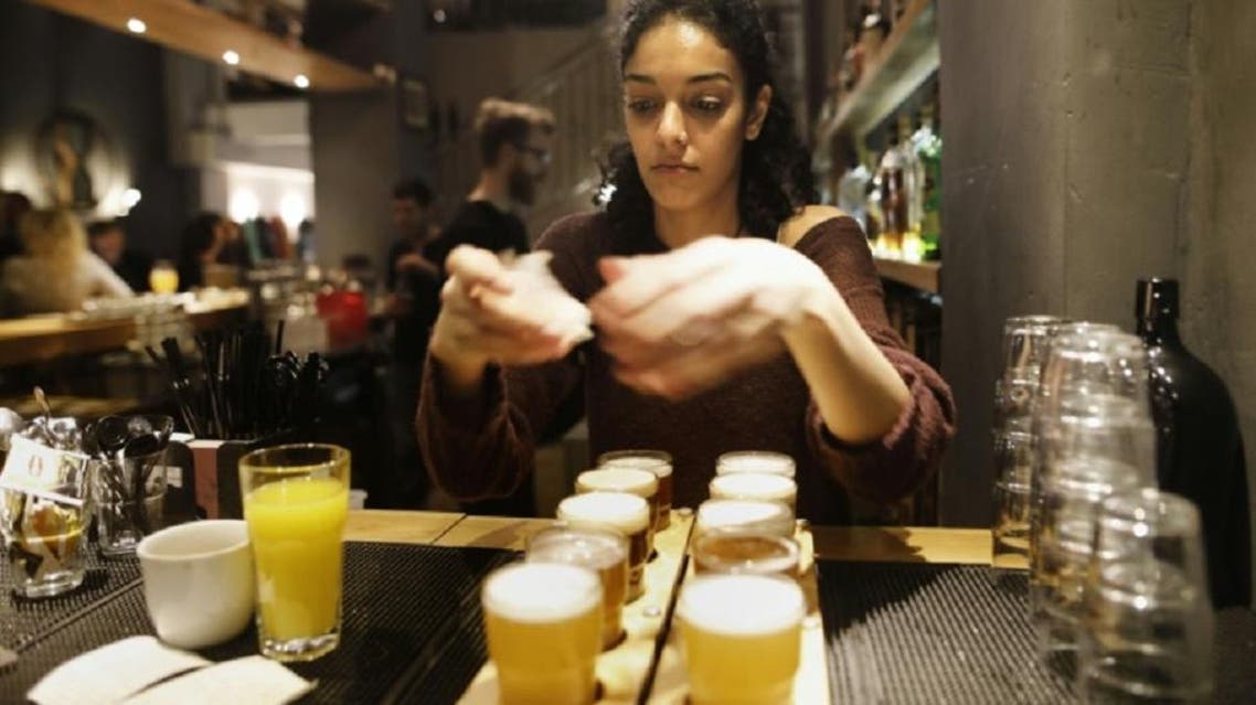 A bartender serves beer at the Libira Brewery pub in the northern Israeli city of Haifa. (AFP)
