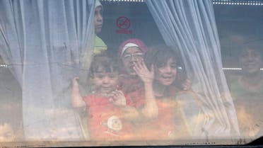 Children evacuees, from the besieged rebel-held Syrian town of Zabadani gesture from inside a bus upon their arrival at an exchange point supervised by the Syrian Arab Red Crescent, in the town of Qalaat al-Madiq, in Hama province, Syria April 21, 2016. (Reuters)