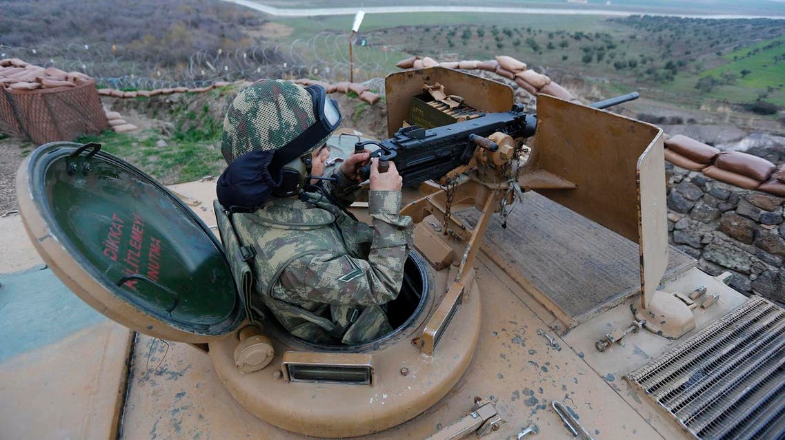 A Turkish soldier on an armoured military vehicle surveys the border line between Turkey and Syria, near the southeastern city of Kilis, Turkey, March 2, 2017. REUTERS/