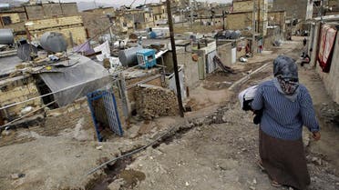 An Iranian woman walks in a poor neighbourhood in the town of Ghaleh Hassan Khan on the southwestern outskirts of Tehran on March 11, 2008. (AFP)