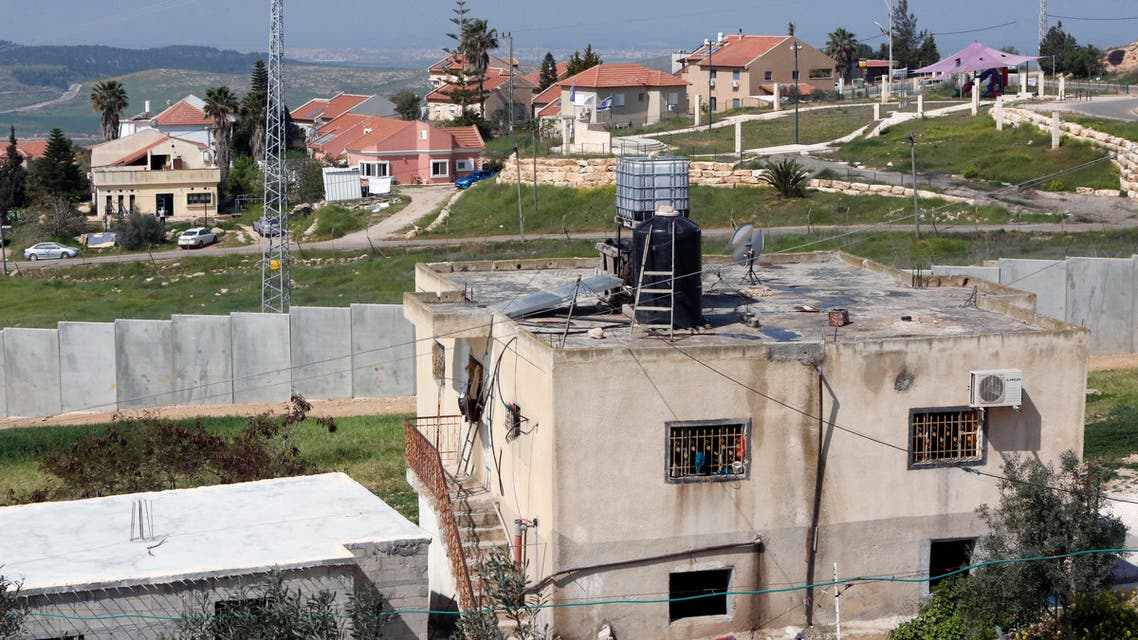 A picture taken on March 25, 2017 from the West Bank town of Ramadin, southwest of Hebron, shows the Israeli settlement of Eshkolot and it's surrounding defensive wall.