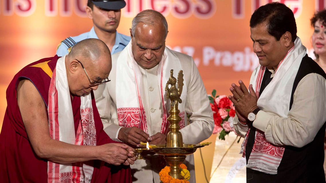 Tibetan spiritual leader the Dalai Lama lights the lamp, as Assam chief minister Sarbananda Sonowal, right, and Governor of Assam Banowari Lal Purohit watch him at the platinum jubilee celebrations of Assam Tribune newspaper in Gauhati, India, on Saturday, April 1, 2017. (AP)