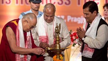 Tibetan spiritual leader the Dalai Lama lights the lamp, as Assam chief minister Sarbananda Sonowal, right, and Governor of Assam Banowari Lal Purohit watch him at the platinum jubilee celebrations of Assam Tribune newspaper in Gauhati, India, on Saturday, April 1, 2017. (AP)