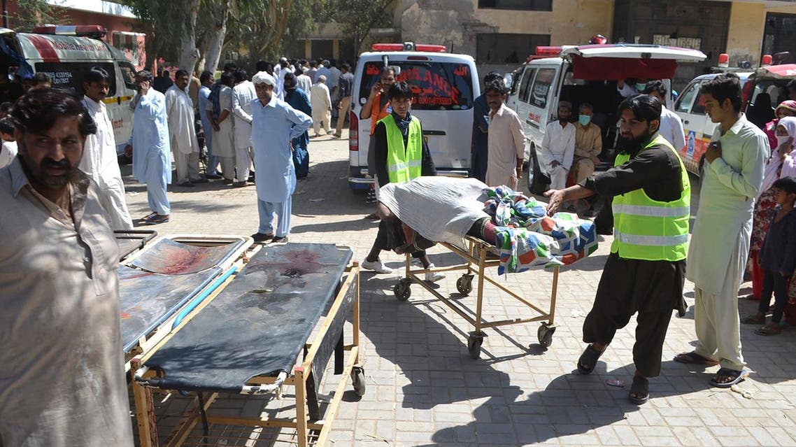 Pakistani volunteers transport the body of a victim murdered at a Sufi shrine by three suspects including the shrine's custodian on the outskirts of Sargodha District in Punjab province on April 2, 2017. (AFP)