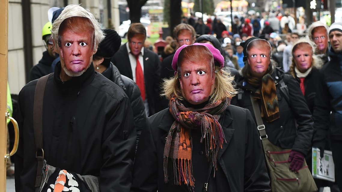 People wearing masks of US President Donald Trump take part in the 32nd Annual April Fools’ Day Parade in New York on April 1, 2017.