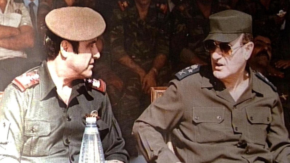 Picture taken in 1984 shows the late Syrian president Hafez al-Assad (R) with his youngest brother Rifaat (L) at a military ceremony in Damascus. AFP
