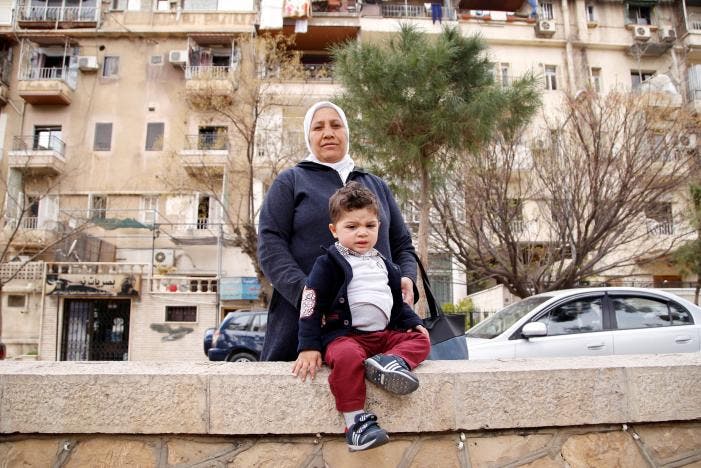 Hajar Saleh poses with her grandson Jaafar at a garden in the Damascus district of Mezzeh, Syria March 30, 2017. REUTERS/Omar Sanadiki