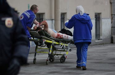 An injured person is helped by emergency services outside Sennaya Ploshchad metro station, following explosions in two train carriages at metro stations in St. Petersburg, Russia April 3, 2017 (Photo: Reuters/Anton Vaganov)