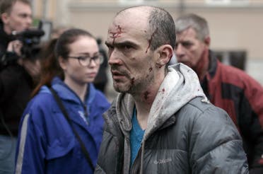 An injured man is helped by medics outside Technological Institute metro station in Saint Petersburg on April 3, 2017 (Photo: Alexander Bulekov/AFP)