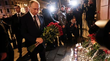 Russian president Vladimir Putin puts flowers down outside Tekhnologicheskiy Institut metro station in St. Petersburg, Russia, April 3, 2017. (AP)