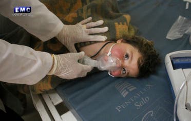This photo provided Tuesday, April 4, 2017 by the Syrian anti-government activist group Edlib Media Center, which has been authenticated based on its contents and other AP reporting, shows a Syrian doctor treating a child following a suspected chemical attack, at a makeshift hospital, in the town of Khan Sheikhoun, northern Idlib province, Syria. The suspected chemical attack killed dozens of people on Tuesday, Syrian opposition activists said, describing the attack as among the worst in the country's six-year civil war. (Edlib Media Center, via AP)