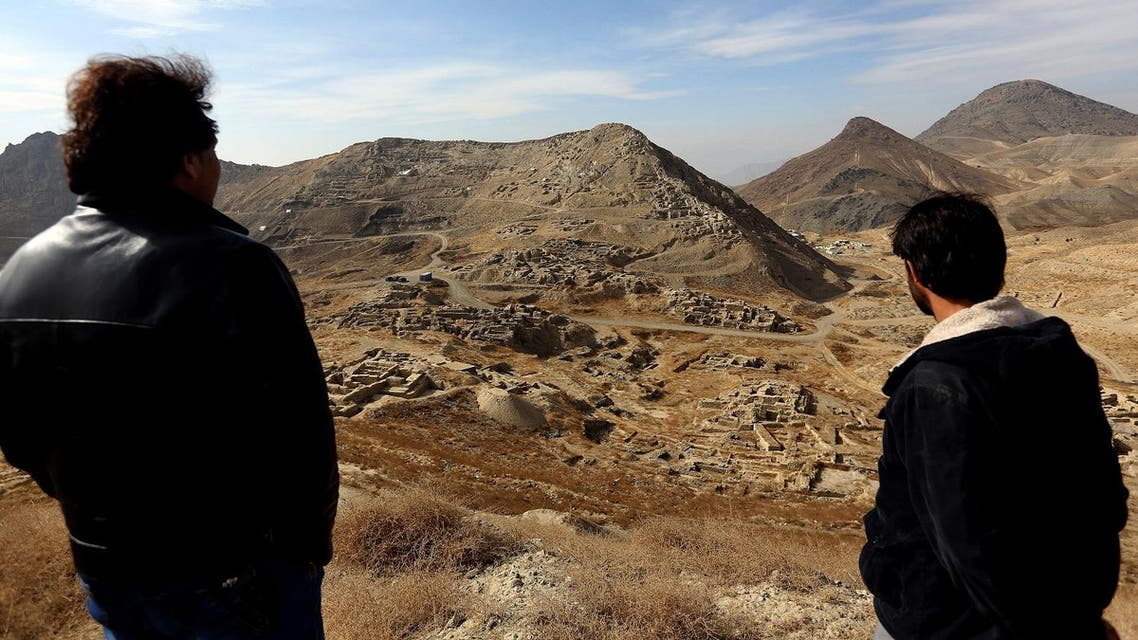 In this Sunday, Jan. 18, 2015, file photo, Abdul Qadir Timor, director of archaeology at the Ministry of Information and Culture, left, looks at the view of Mes Aynak valley, some 40 km southwest of Kabul, Afghanistan. (AP)