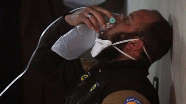 A civil defense member breathes through an oxygen mask, after what rescue workers described as a suspected gas attack in the town of Khan Sheikhoun in rebel-held Idlib. (Reuters)