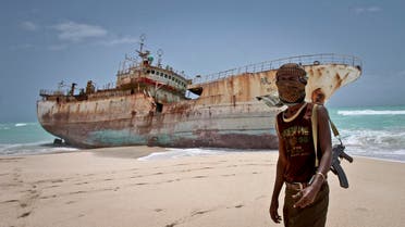 A masked Somali pirate Abdi Ali stands near a Taiwanese fishing vessel (File Photo: AP/Farah Abdi Warsameh)