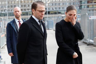 Victoria, Crown Princess of Sweden and Prince Daniel lay flowers at a fence at the scene of a truck attack near the Ahlens department store in Stockholm April 8, 2017. (Reuters)