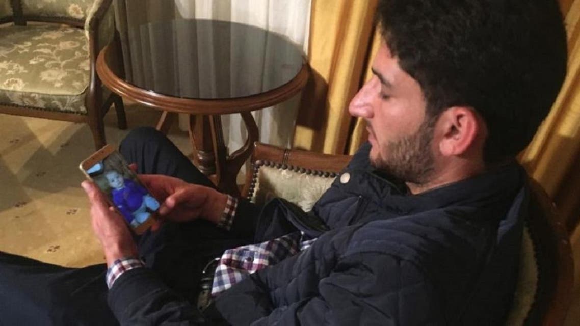 Abdel Hameed Alyousef, 29, of Khan Sheikhoun, Syria, looks at photographs of his deceased children on his cell phone showing a photo of his deceased son Ahmed, in Antakya, southeastern Turkey, late Friday, April 7, 2017. (AP)