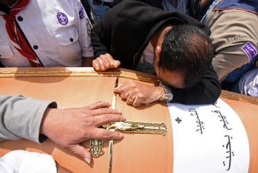Men mourn over the coffin of one of the victims of the blast at the Coptic Christian Saint Mark's church in Alexandria the previous day during a funeral procession at the Monastery of Marmina in the city of Borg El-Arab, east of Alexandria, on April 10, 2017. Egypt prepared to impose a state of emergency after jihadist bombings killed dozens at two churches in the deadliest attacks in recent memory on the country's Coptic Christian minority. (AFP)