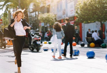 Business woman rushing to work running late. (Stock image)
