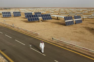 A Saudi man walks on a street past a field of solar panels at the King Abdulaziz city of Sciences and Technology, Al-Oyeynah Research Station May 21, 2012. (Reuters)