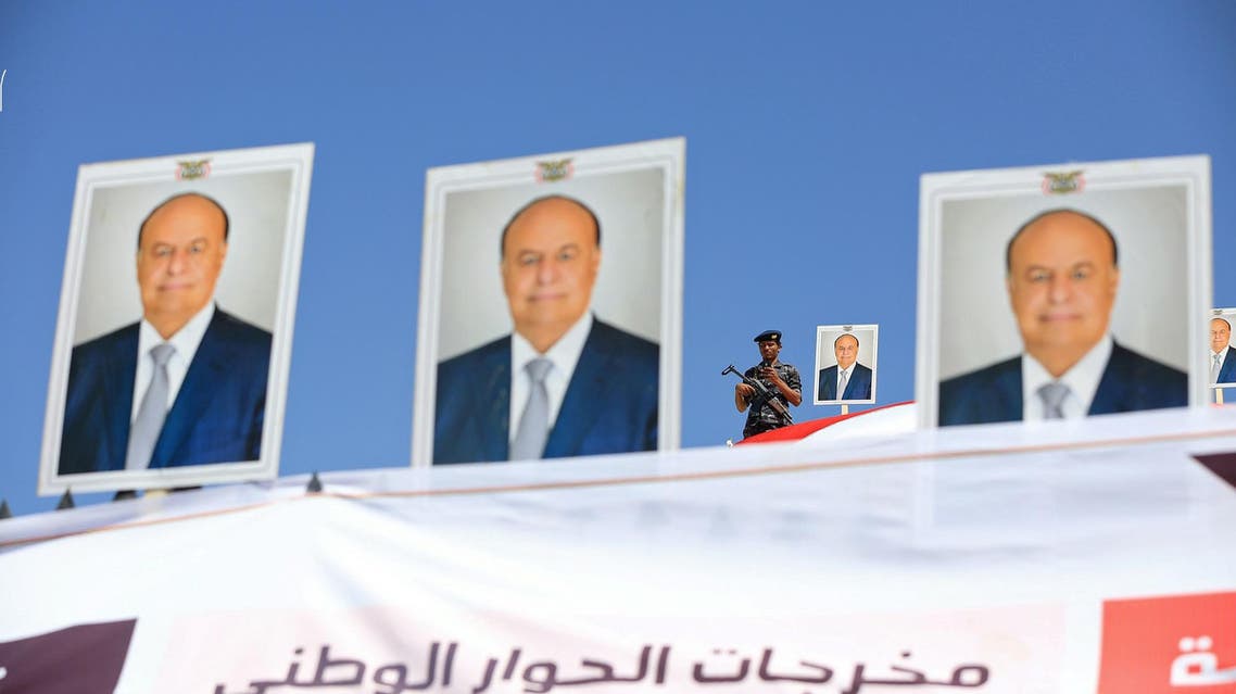A police trooper stands by a poster of Yemen's President Abd-Rabbu Mansour Hadi on a government building during a demonstration to show support to Hadi in the country's northern city of Marib November 3, 2016. (Reuters)