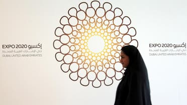 A woman walks past the logo of the Expo 2020 in Dubai, United Arab Emirates, April 3, 2017. (Reuters)