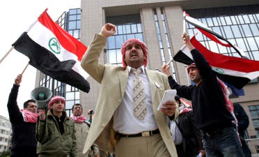 An unidentified man chants as others wave the flag of the Al Ahwaz Liberation Organization during a protest in front of the European Council building in Brussels, on April 18, 2008. (AP)