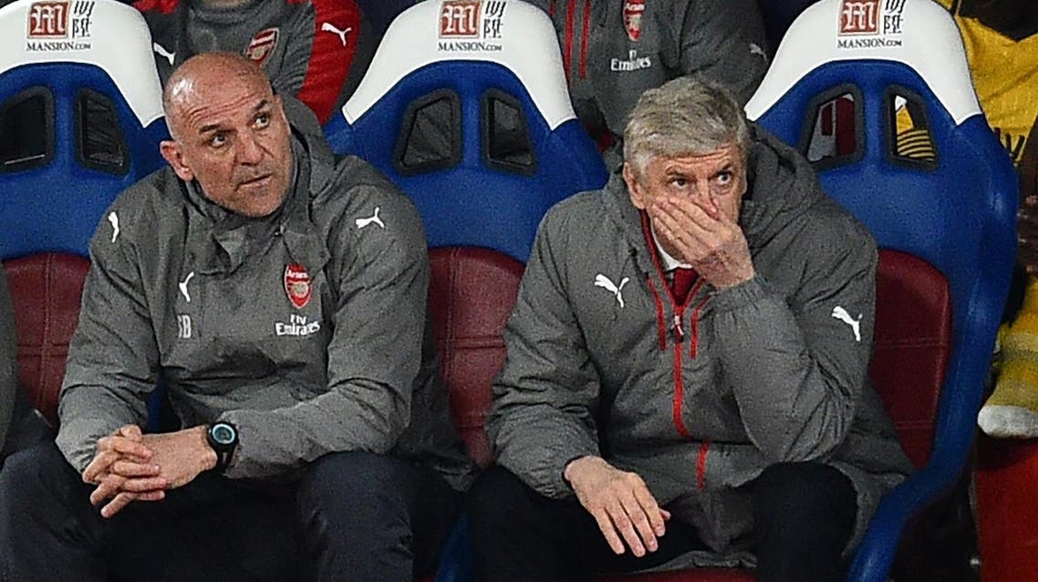 Arsenal's French manager Arsene Wenger (R) and assistant Steve Bould gesture in their seats during the English Premier League football match between Crystal Palace and Arsenal at Selhurst Park in south London on April 10, 2017. Crystal Palace won the game 3-0. AFP