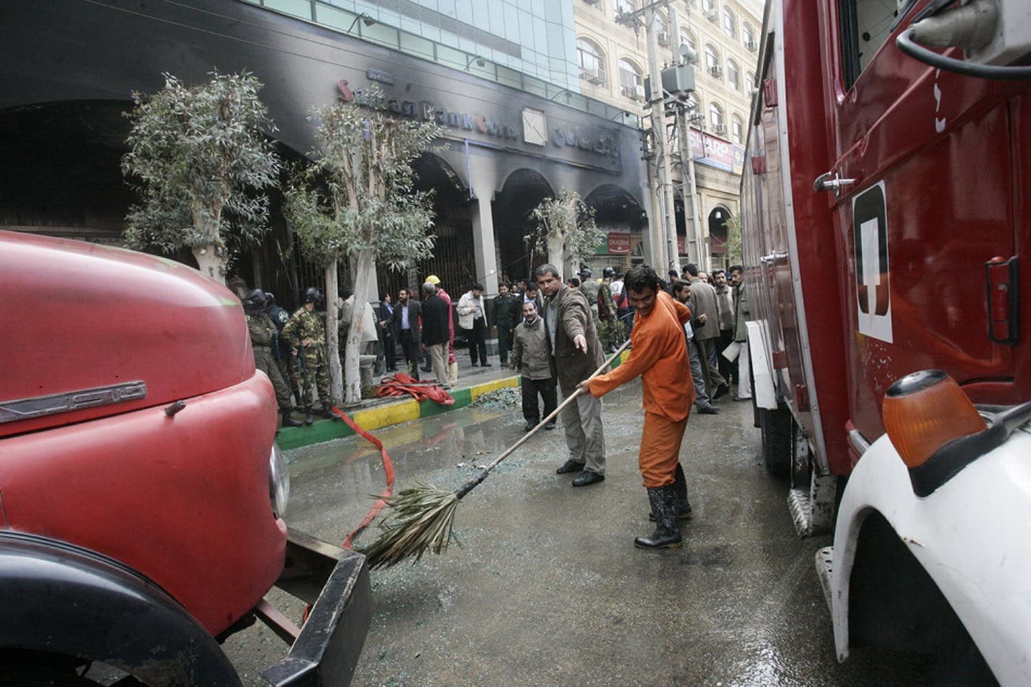 Iranian rescuers clean the scene of a bomb attack in Ahwaz where a scheduled visit by President Mahmoud Ahmadinejad had been cancelled at the last minute, 24 January 2006. (File photo: AFP)